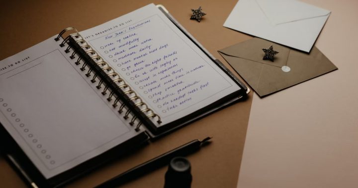 A tidy desk setup featuring a planner, to-do list, envelopes, and a pen.